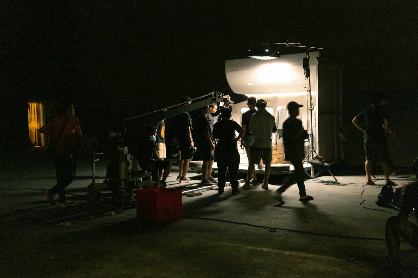 Film crew at a camera on a dark set